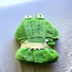 A green alligator baby bath wrap